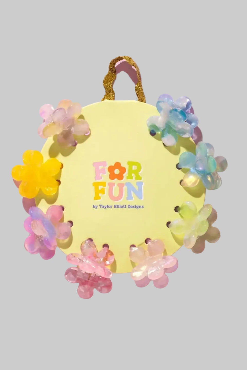 Mini hair claw clips shaped as flowers in a variety of colors, pink, blue, and yellow.